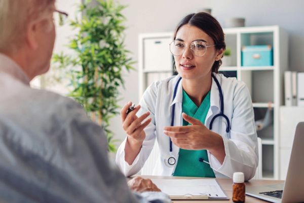 female doctor talking to male patient