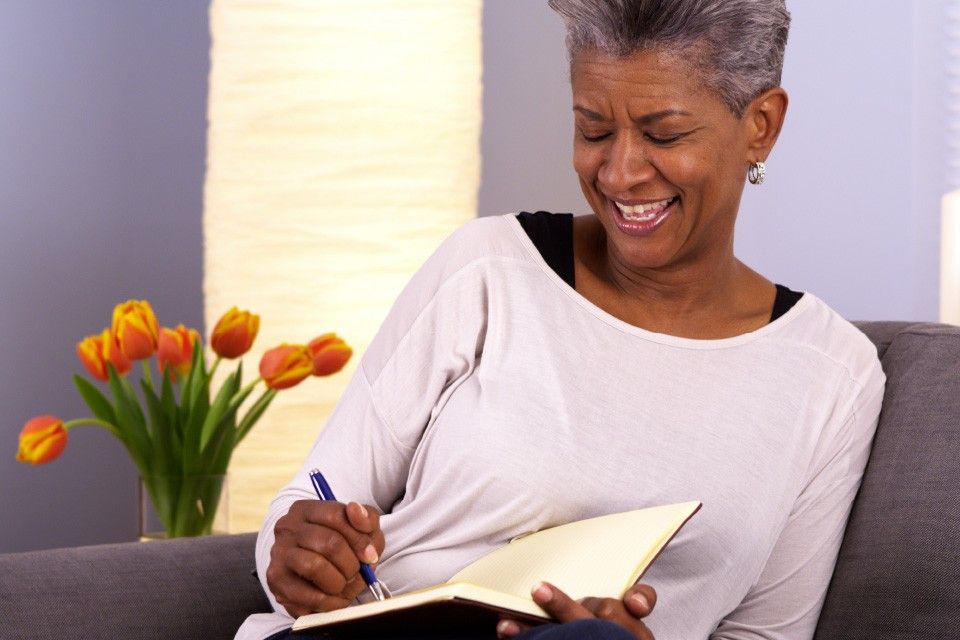 Woman smiling while journaling